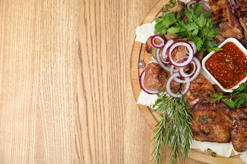 Delicious roasted meat served on wooden table, top view. Space for text