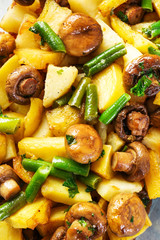 Baking dish with tasty cooked mushrooms and green beans, closeup