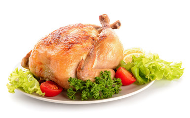 Plate with baked chicken on white background