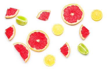 Fresh cut grapefruit, lemon and lime on white background