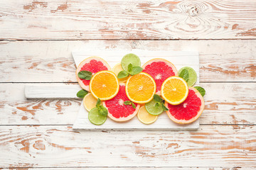 Fresh cut citrus fruits on wooden background
