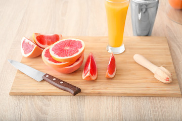 Composition with fresh cut grapefruit on kitchen table