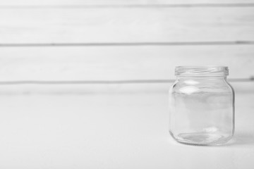 Empty glass jar on white table, space for text