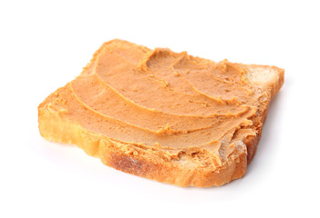 Toasted bread with tasty peanut butter on white background