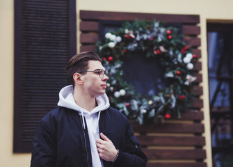 stylish young man posing in a black jacket