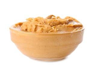 Tasty peanut butter in bowl on white background