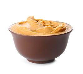 Tasty peanut butter in bowl on white background