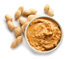 Tasty peanut butter in bowl on white background