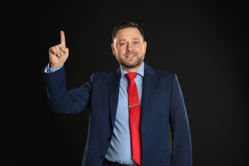 Portrait of happy mature man on black background