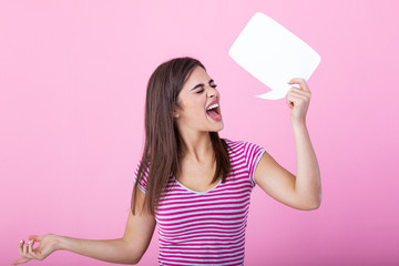 cute woman screaming in blank speech bubble isolated background. Young woman holding a speech...