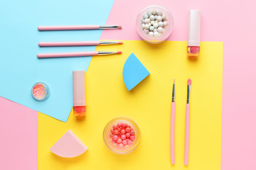 Set of decorative cosmetics and accessories on color background