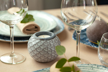 Table setting set with candles and plant branches