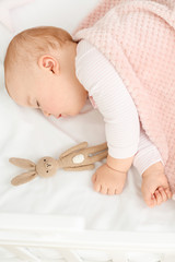 Cute sleeping little baby in bed