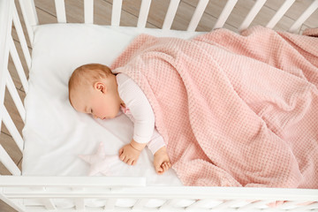 Cute sleeping little baby in bed