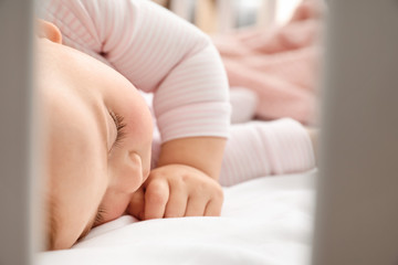 Cute sleeping little baby in bed
