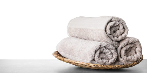 Fresh bath towels on table against white background. Space for text