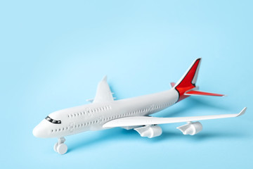 Obraz na płótnie Canvas Toy plane on blue background. Logistics and wholesale concept