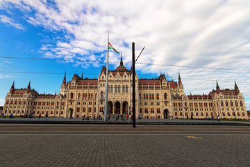 Fototapeta na wymiar Scenic landscape view of The Hungarian Parliament Building. Square in front of the building with many tourists. It is notable landmark of Hungary and a popular tourist destination in Budapest