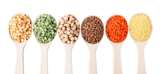 Different types of legumes and cereals on white background, top view. Organic grains