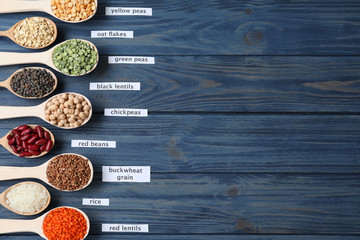 Flat lay composition with different types of legumes and cereals on blue wooden table, space for text. Organic grains