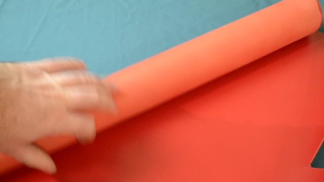 leather geniune red. Rolling hand. Closeup video