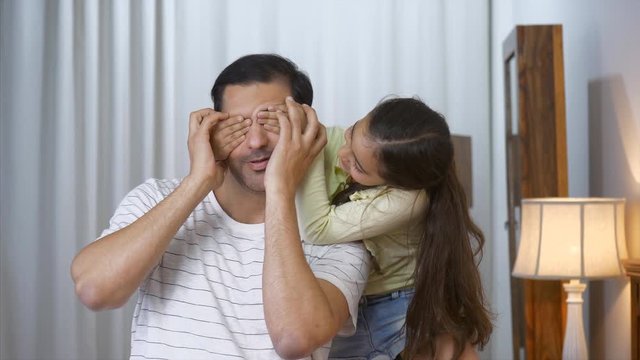 Father and Daughter Playing - Indian clip of little girl surprising her father by covering his eyes from behind. Indian Stock Video of a cute daughter playing guessing games with her father. Happy ...