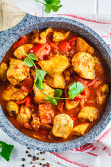 Jalfrezi chicken in fried pan with a bowl of rice, top view. Traditional indian cuisine concept.