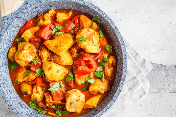 Jalfrezi chicken in fried pan with a bowl of rice, top view, copy space. Traditional indian cuisine concept.