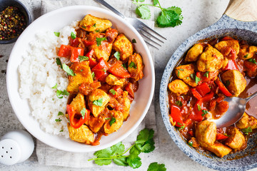 Jalfrezi chicken with rice in white bowl, top view. Traditional indian cuisine concept.