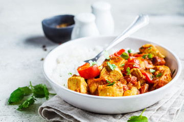 Jalfrezi chicken with rice in white bowl, copy space. Traditional indian cuisine concept.