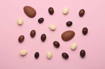 Chocolate Easter eggs on color background