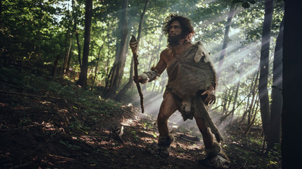 Primeval Caveman Wearing Animal Skin Holds Stone Tipped Spear Looks Around, Explores Prehistoric...