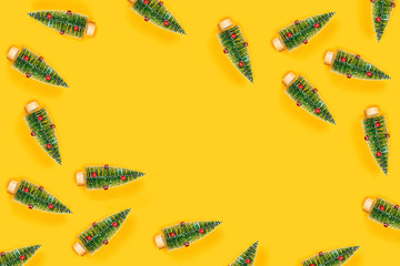 Christmas and New year pattern with yellow background and many christmas trees. Flat lay, top view, copy space.