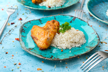 Plate with tasty rice and chicken on color background