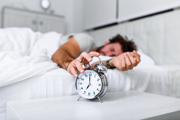 Sleep longer. Health care concept. Stages of sleep. Man awake unhappy with alarm ringing. Although...