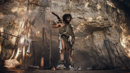 Primeval Caveman Wearing Animal Skin Holds Stone Tipped Hammer Looks Around Prehistoric Forest,...