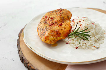 Plate with tasty rice and chicken on white table, closeup