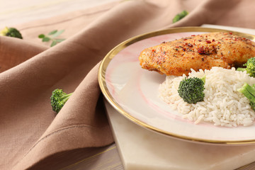 Plate with tasty rice and chicken on table, closeup