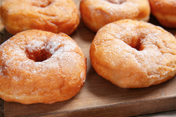Sweet tasty donuts on table