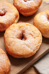 Sweet tasty donuts on table
