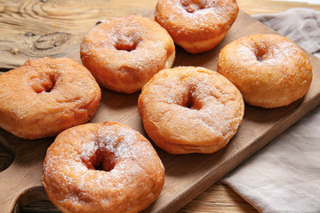 Sweet tasty donuts on table