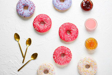 Fototapeta na wymiar Sweet tasty donuts on white background