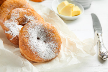 Sweet tasty donuts on table