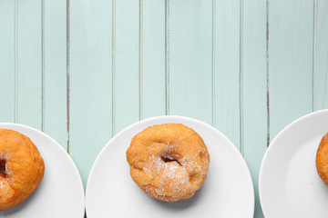 Sweet tasty donuts on wooden table