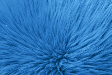 Faux fur as background, top view. Color of the year 2020 (Classic blue)