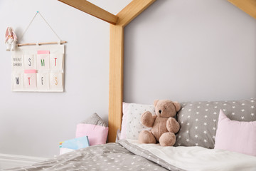 Stylish child room interior with comfortable bed