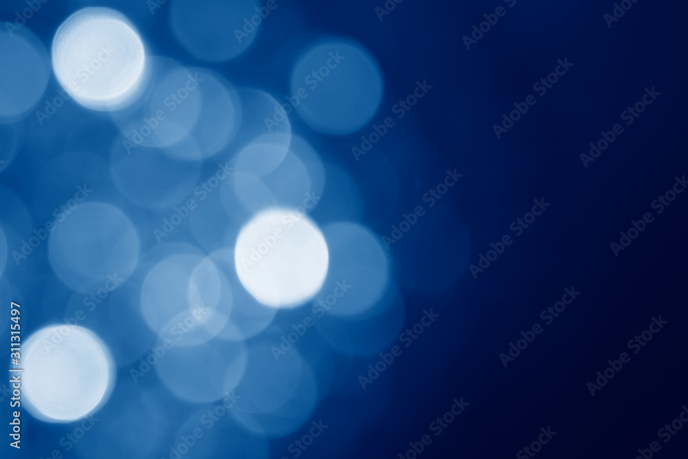 Aufkleber abstract blurred circular bokeh lights background toned in trendy classic blue color of the year 202