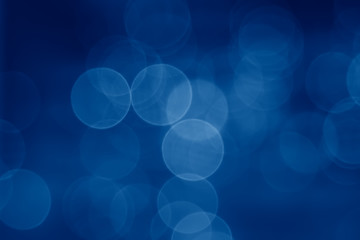 abstract  pale blurred circular bokeh lights background toned in trendy Classic Blue color of the Year 2020