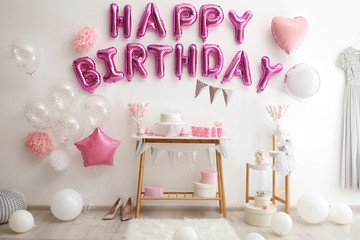Phrase HAPPY BIRTHDAY made of pink balloon letters in decorated room - obrazy, fototapety, plakaty