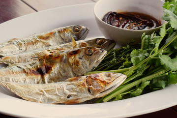 Picture of food made from grilled mackerel With sweet fish sauce and vegetables in a delicious white dish in Samut Sakhon province, Thailand